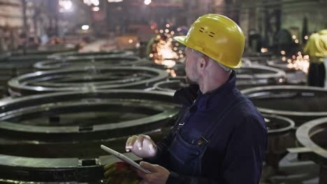 supervising engineer inspecting metal fabrication plant