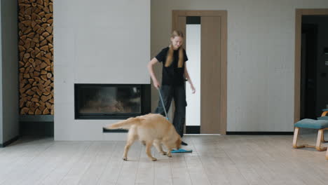 woman cleaning a living room with a dog