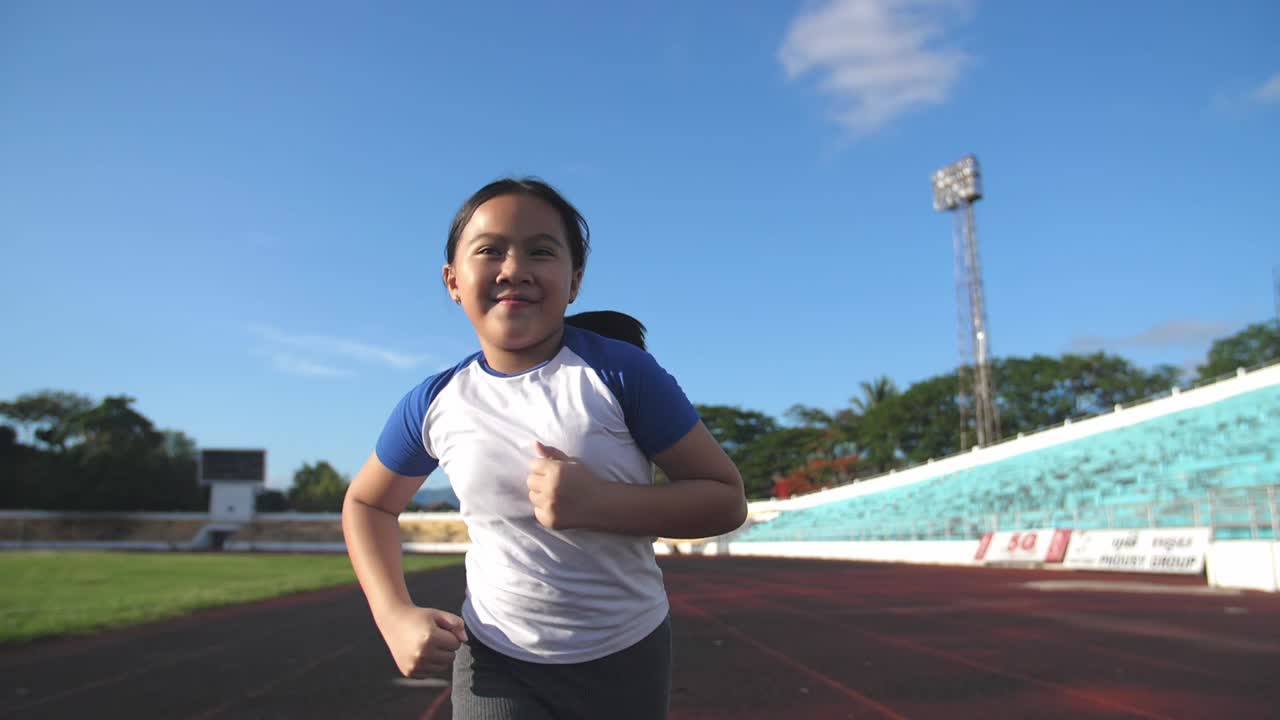 Asian Child Running In Stadium