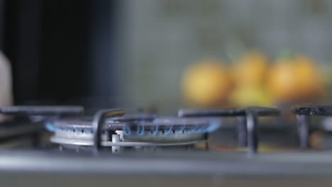 Side-view-of-stove-burner-being-lit