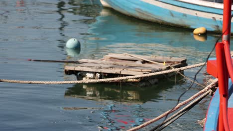 wooden rafts and boats tied up at a pier