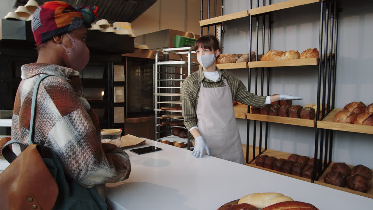 African American Woman in Mask Buying Bread in Bakery
