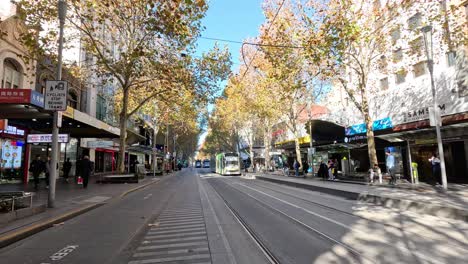 tram travels down swanston street in melbourne