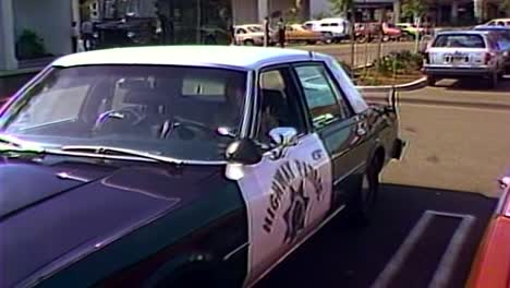 1980s highway patrol cop car driving and parking