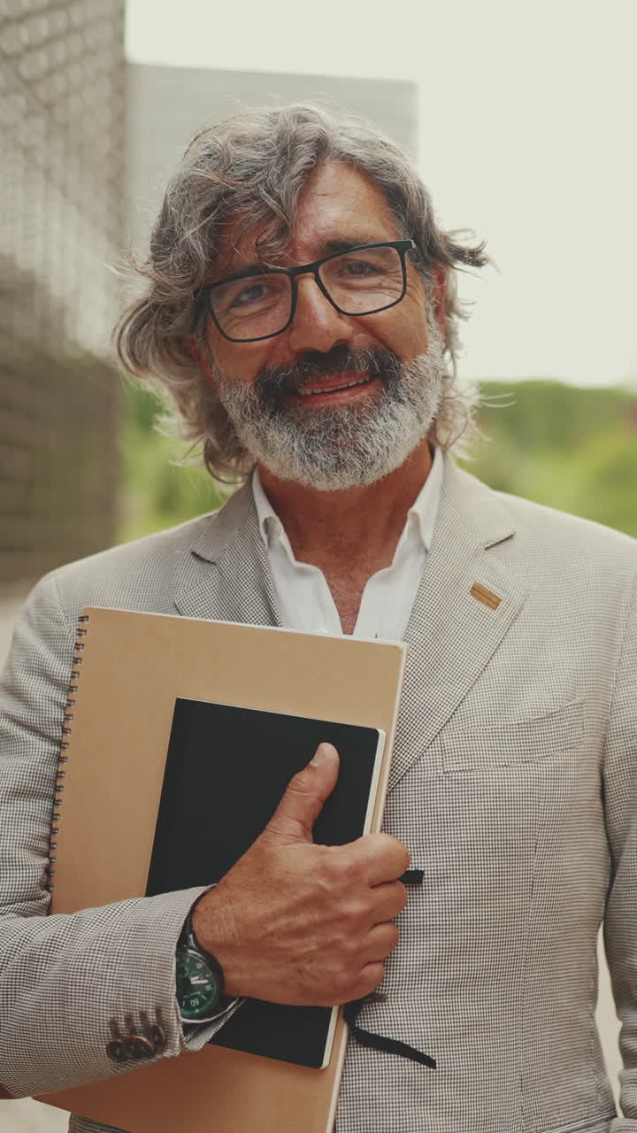 Portrait of a Smiling Man with Notebooks