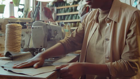 african american female shoemaker working in workshop