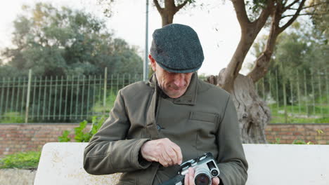 elderly man prepares his vintage camera for filming