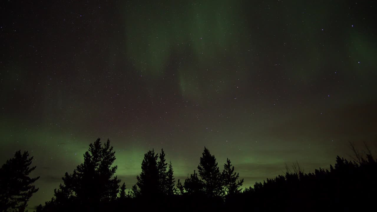 Northern lights rolling past a starscape timelapse in Alberta Canada