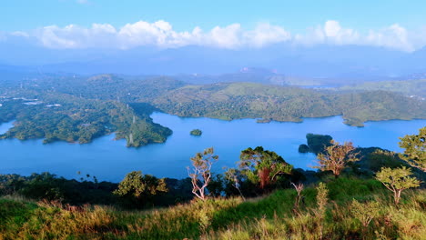 coming closer to the edge of the mountain. revealing view on the beautiful azure waterscape among the hills. sri lanka, south asia.