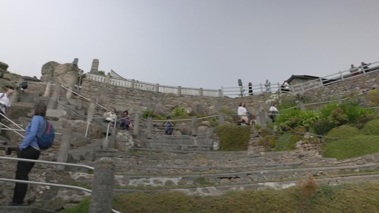 People exploring the Minack Theatre outdoor stone amphitheater
