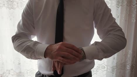 groom&#039;s preparing his watch at home