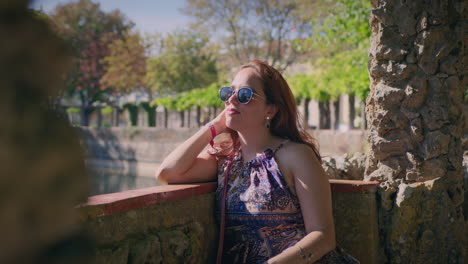 woman walks on a balcony by the river and rests