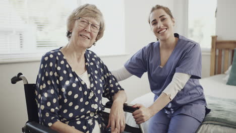 nurse supporting elderly woman in wheelchair