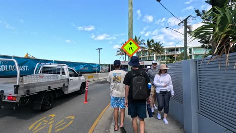 people walking near parked vehicles and construction site