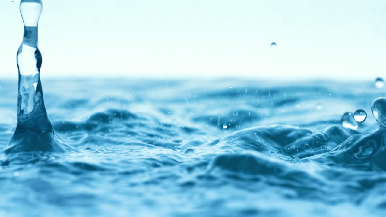 Rain water drops falling in super slow motion.