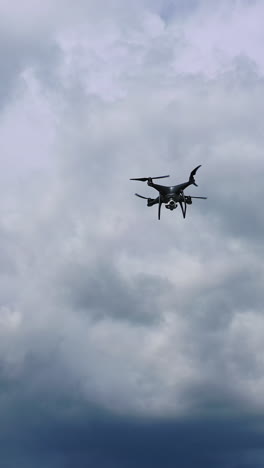 flying drone over fields. drone capturing aerial shots using camera against a blue sky vertical video