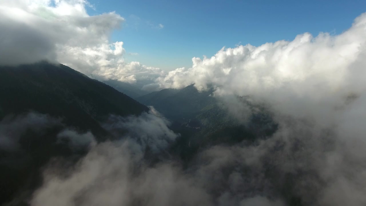 Aerial View of Mountain Valley Partially Obscured by Clouds