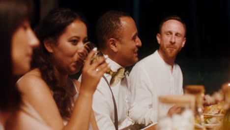 friends enjoying a dinner party outdoors at night