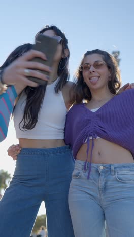 three young women taking a selfie outdoors
