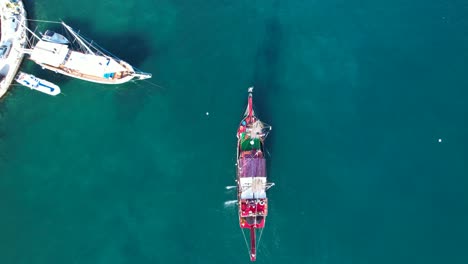 tour ship approaching saranda's pier in the blue bay, inviting summer vacation excitement, top-down view