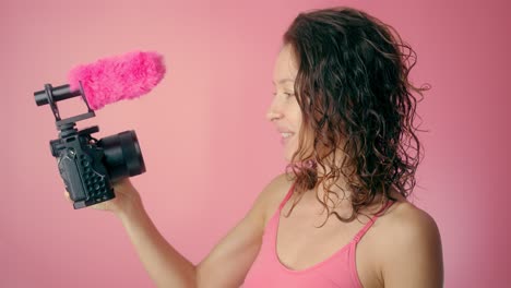 Woman Recording Video with Camera and Microphone