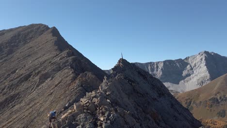 hiker climbing toward peak with spike slow motion revealed kananaskis alberta canada