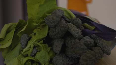 cacerola lenta en el interior con col rizada y hojas de nabo del mercado del agricultor
