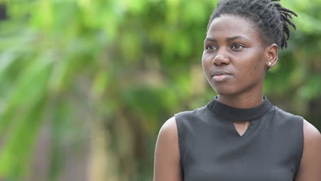 young happy beautiful african businesswoman thinking outdoors