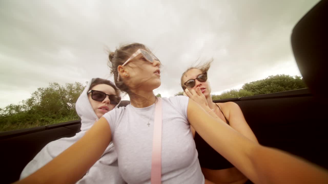 Group of friends on a road trip in a convertible