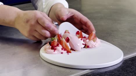 presenting a well done dessert, composed of ice cream, cream and strawberries