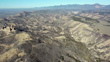 aerial view of a hilly landscape with a castle