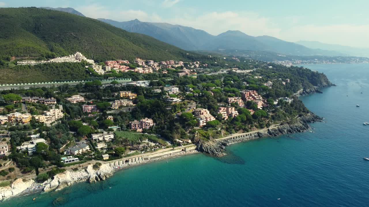 Aerial view of a coastal town with mountains
