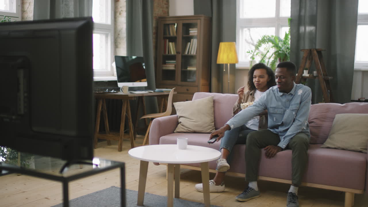 Afro Couple Starting To Watch TV At Home