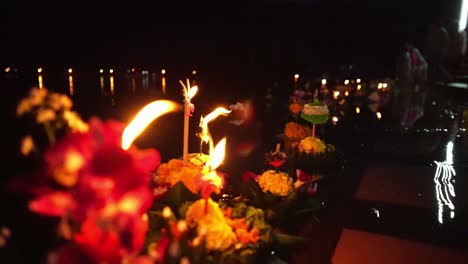 Loy-Krathong-Festival:-Close-up-shot-of-Colorful-Krathongs-with-a-burning-candles-and-incense-on-top