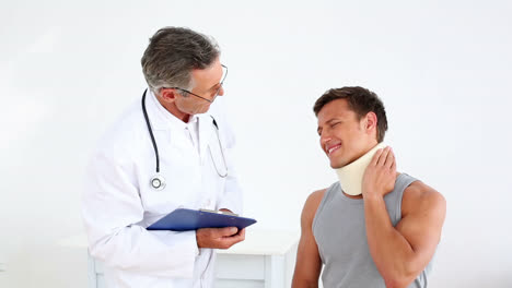 sportsman in neck brace talking to doctor