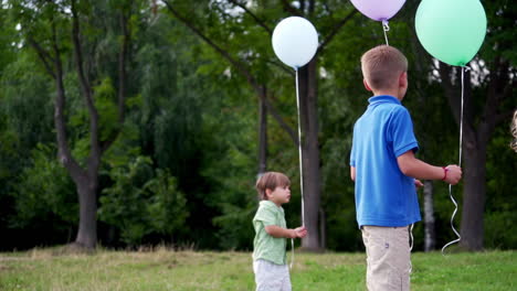 children playing with baloons. cute children celebrating birthday with baloons