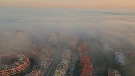 thick fog covering town cozy morning drone view. autumn mist lying on streets
