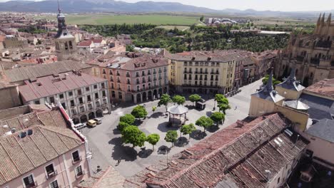 plaza mayor in segovia spain, aerial circling above rooftops, sunny day