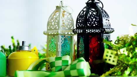 arabic lantern and ribbon ketupat on green background