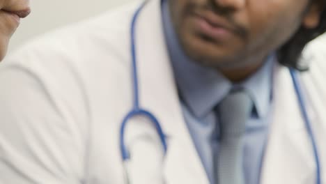 Patient-puts-Hands-on-Chin-While-Talking-to-Doctor