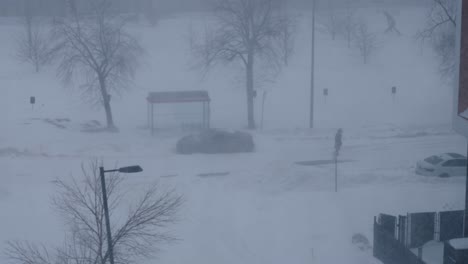 person walking through heavy snowstorm blizzard during winter