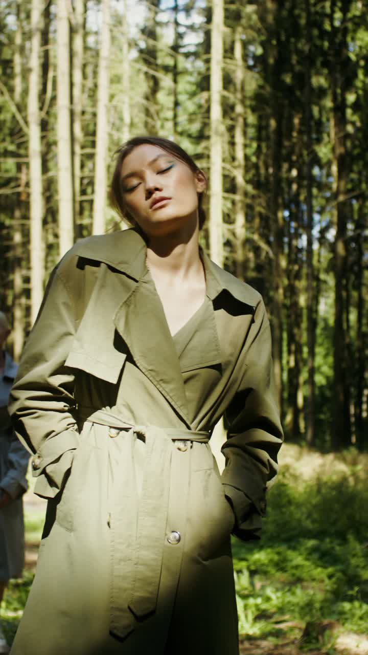 Fashionable women in trench coats in a forest