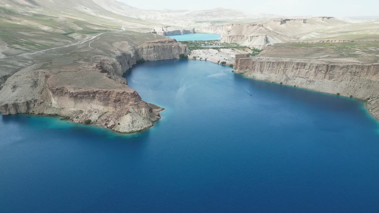 Band E Amir Drone Aerial, Afghanistan. Pristine turquoise lake oasis, lush trees in desert landscape