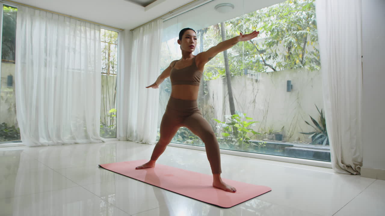Asian Female Athlete Doing Warrior Pose