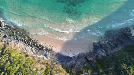 cinematic aerial drone footage of a dramatic cliff at noosa national park, showcasing the stunning queensland coastline.