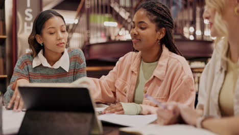 university students collaborating in library study session