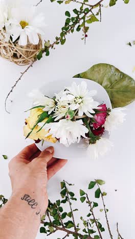 hand holding a plate of flowers