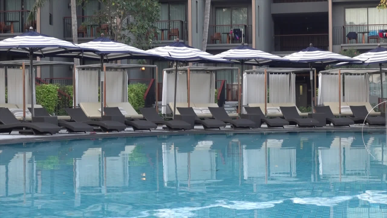 Bed pool with umbrella around swimming pool in hotel resort for vacation concept-7