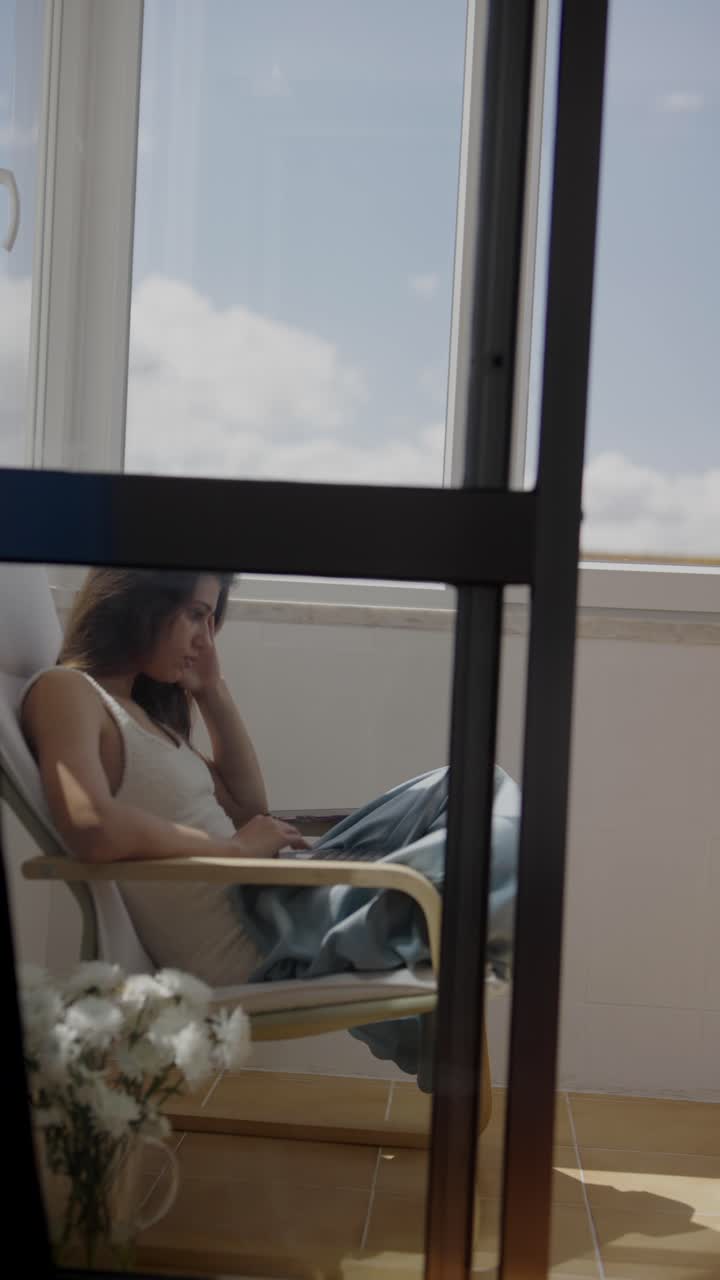Woman Working/Relaxing on Balcony