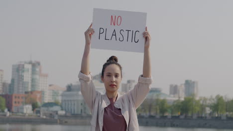 woman holding anti-plastic protest sign
